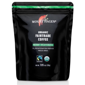 Pouring Mount Hagen decaf instant coffee into hot water