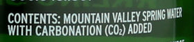 The Mountain Valley Sparkling Lime being poured, lively bubbles and zing.