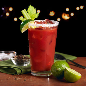 Pouring Mr & Mrs T Bloody Mary mix into a glass for a spicy cocktail