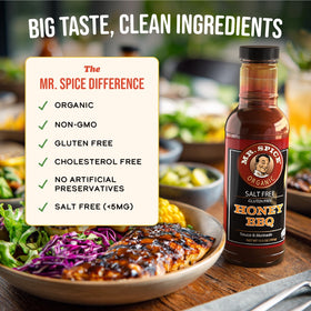 Mr. Spice Organic Honey BBQ Sauce on the grill with meat and vegetables sizzling
