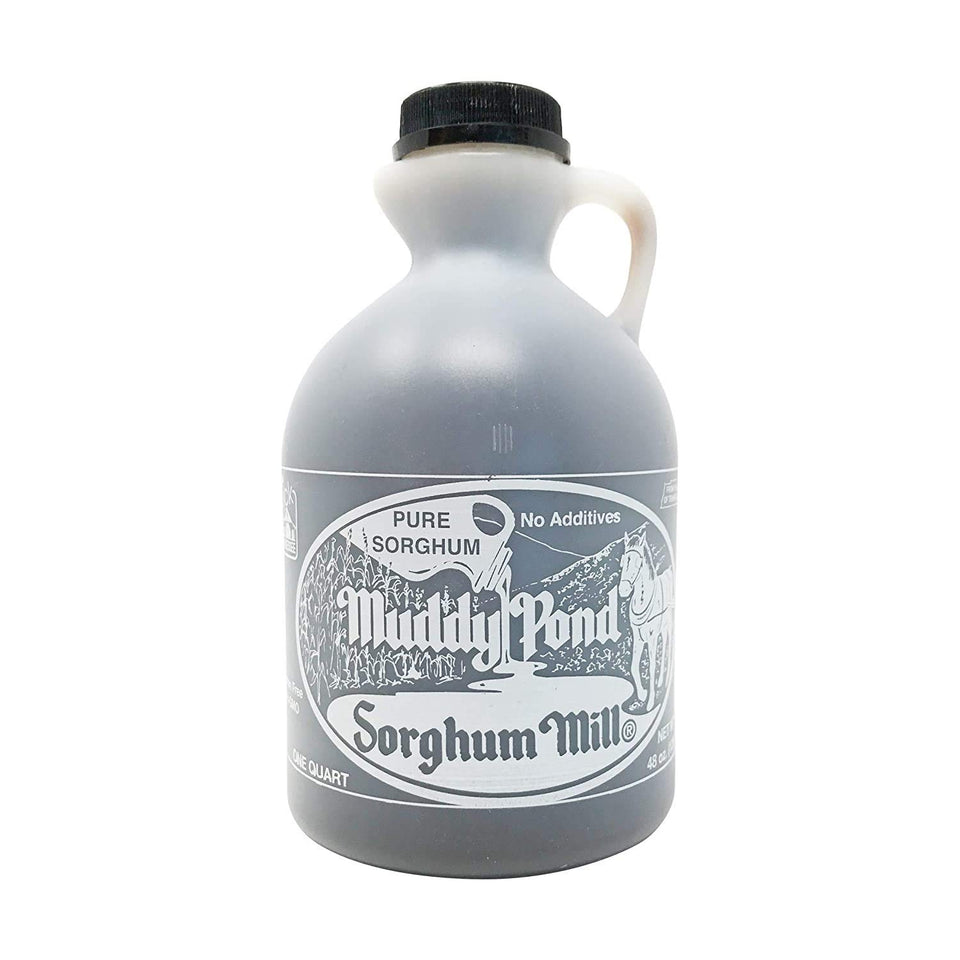 Muddy Pond Sorghum Mill bottle on a rustic table, ideal for drizzling on warm biscuits.
