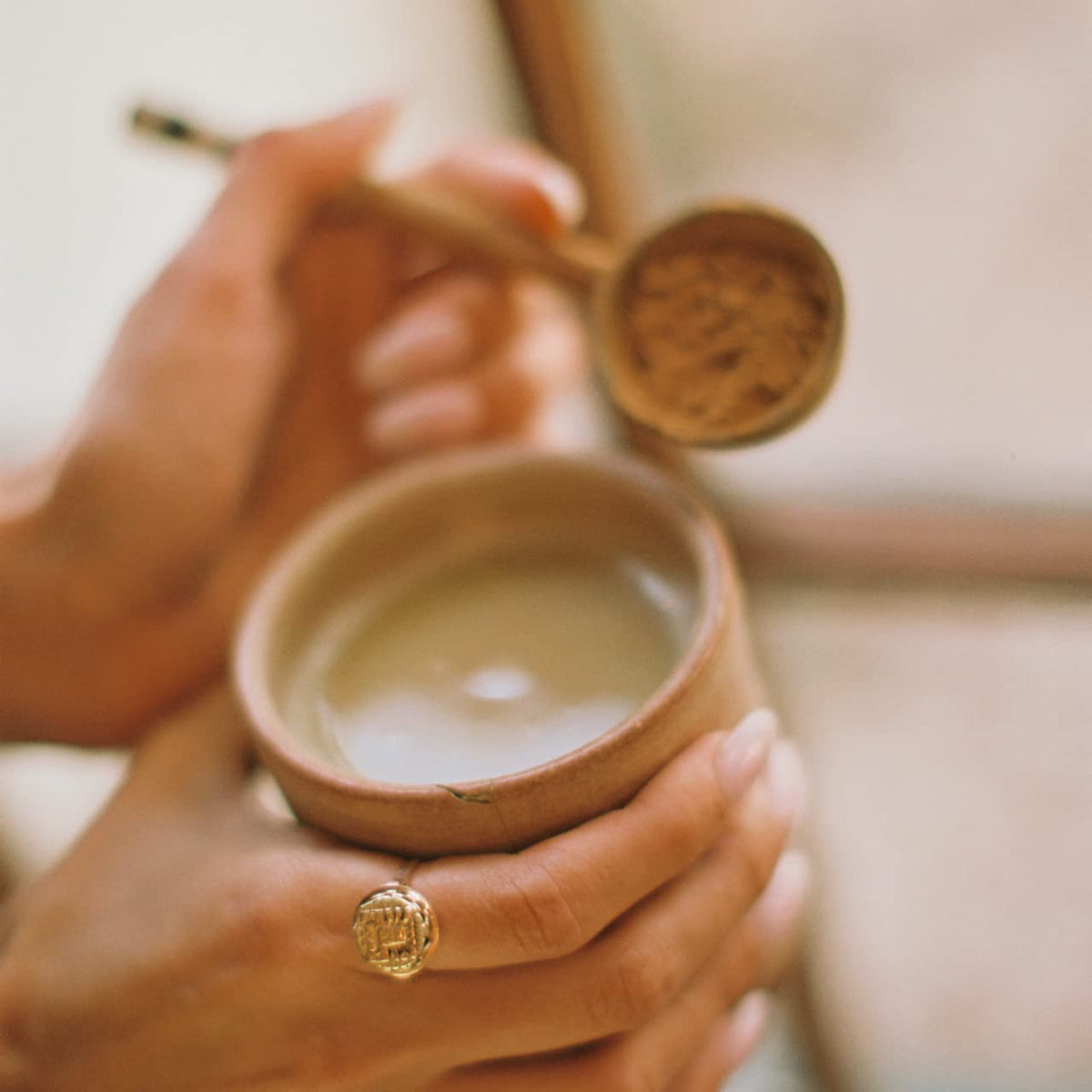 Tea cup featuring mudwtr coconut creamer as a dairy-free addition