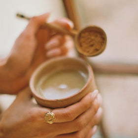 Tea cup featuring mudwtr coconut creamer as a dairy-free addition