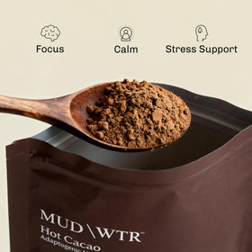 Close-up of MudWTR Hot Cacao powder for vibrant flavor and texture.