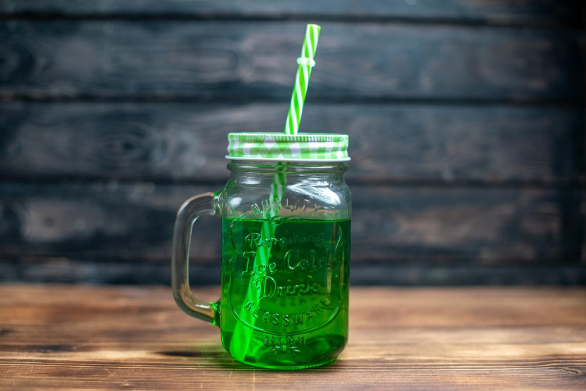 Glass with Berliner Weisse and Waldmeister Syrup, a classic pairing.