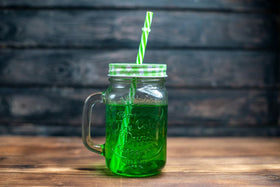 Glass with Berliner Weisse and Waldmeister Syrup, a classic pairing.