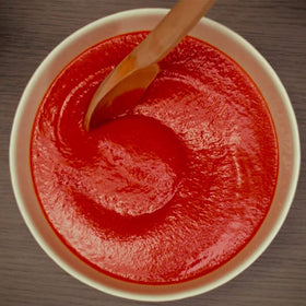 Mutti Organic Tomato Puree Passata pour spout demonstrates smooth texture ideal for bases.