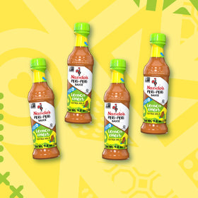 Nando's Peri-Peri sauce bottle pouring for wing and chicken glaze