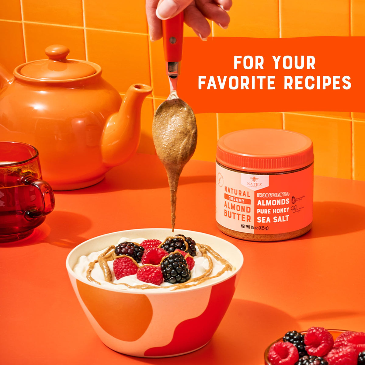 Nate's Honey Almond Butter on a spoon suggests convenient snacking right from the jar.
