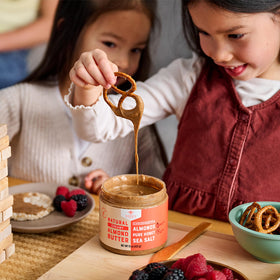 Nate's Honey Almond Butter paired with fruit spread for a quick, balanced treat.