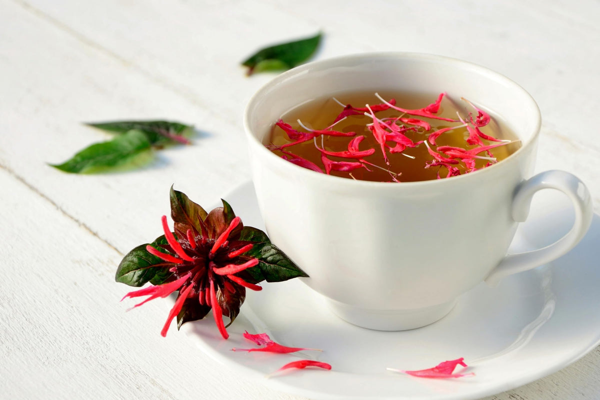 Preparing a tea infusion with Naturegrail Bergamot petals in a cup.