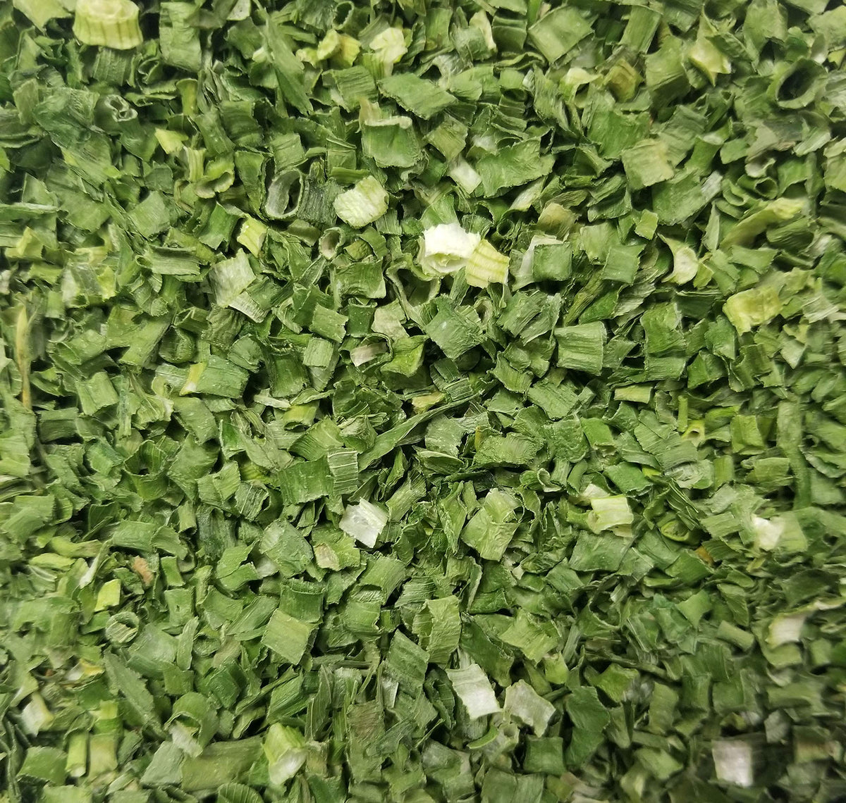 Naturejam chives freeze-dried flakes closeup showing vibrant green color for easy seasoning.