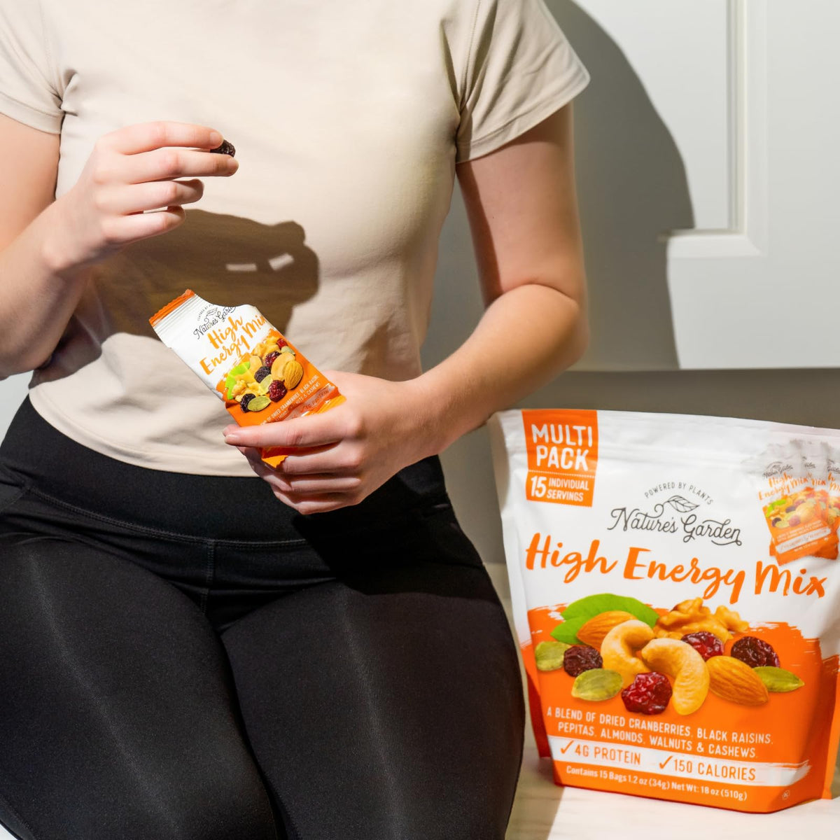 Nature's Garden High Energy Mix snack bag in hand ready to fuel