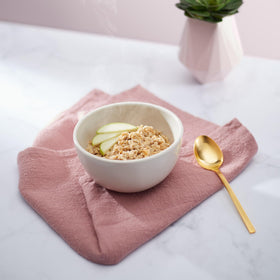 Nature's Path Apple Cinnamon Oatmeal bowl prepared with hot water for a cozy meal.
