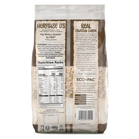 Spoon scooping Heritage O's with visible oats and quinoa texture.