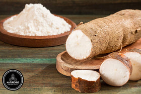 Cassava flour being scooped to measure for dough preparation with Naturevibe Botanicals.