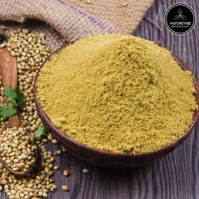 Naturevibe Botanicals coriander seed powder closeup reveals vibrant, finely ground texture for quick mixing.