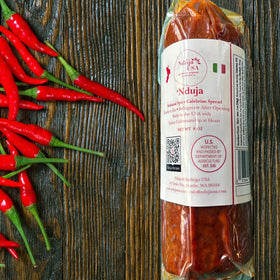Nduja USA cylindrical pack ready to spread on crusty bread for bold flavor