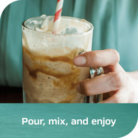 Pouring NESCAFÉ Espresso Concentrate Black into a glass for quick iced coffee.