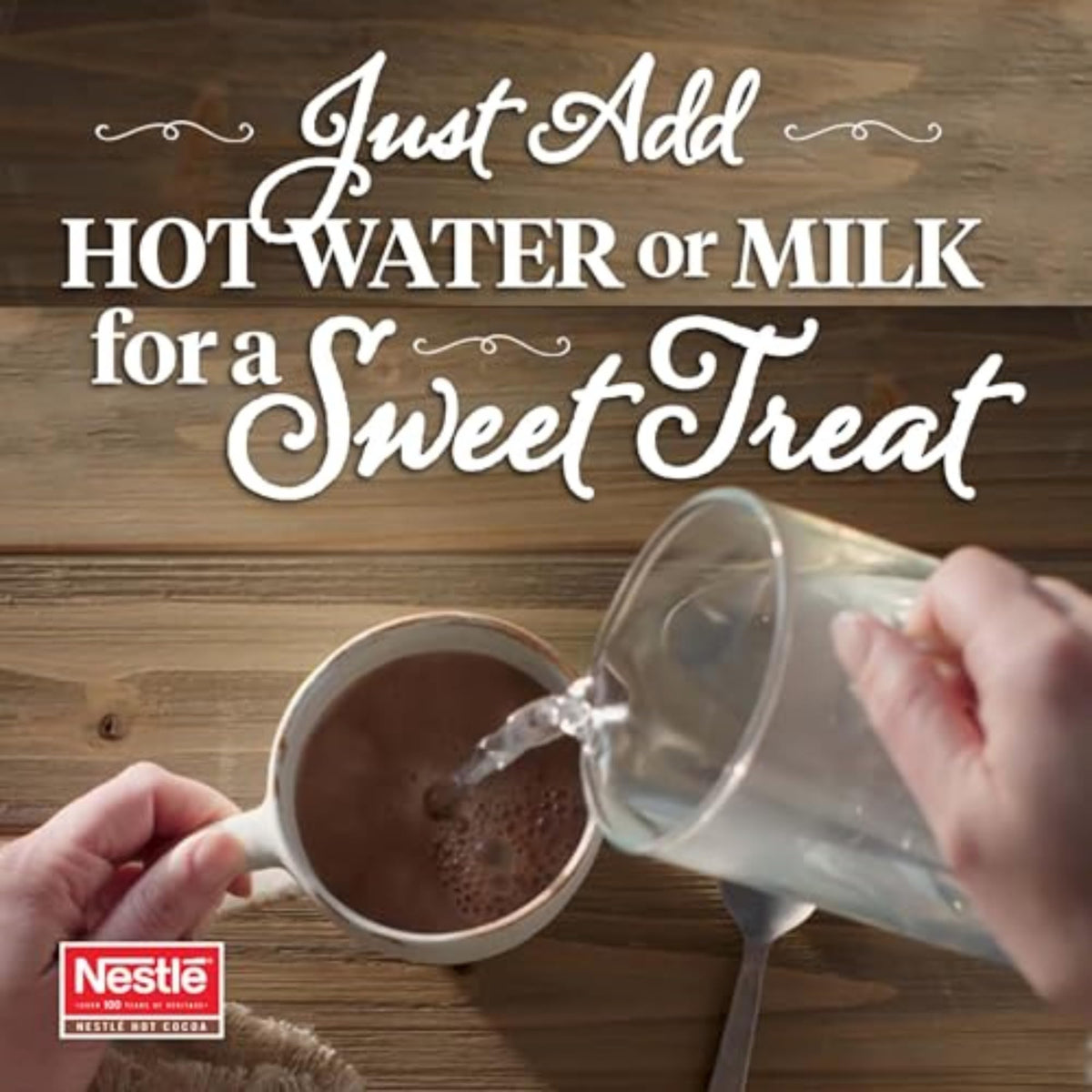 Nestlé Hot Cocoa being stirred in a cup for creamy texture.