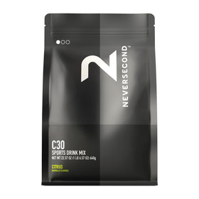 Neversecond C30 powder being poured from a tub for rapid hydration during training.