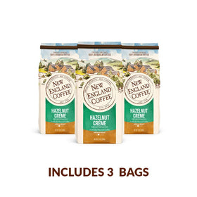 New England Hazelnut Creme Decaf sustainable cup highlights environmental initiative.