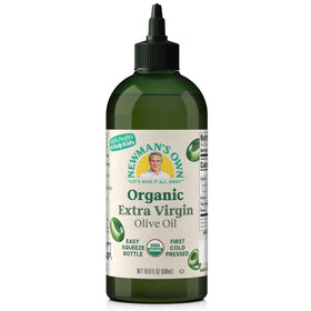 Newman's Own Organic EVOO bottle pouring a perfect drizzle on a salad for flavor.