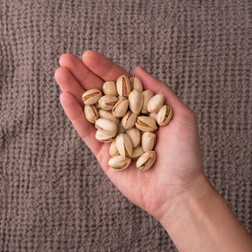 Nichols Farms pistachios on a serving board, perfect for gatherings.