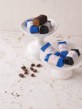 Niederegger pistachio marzipan enrobed in dark chocolate offers nutty richness.