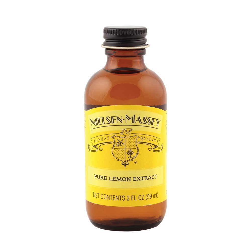 Nielsen-Massey Pure Lemon Extract bottle pour for quick lemon flavor in desserts.
