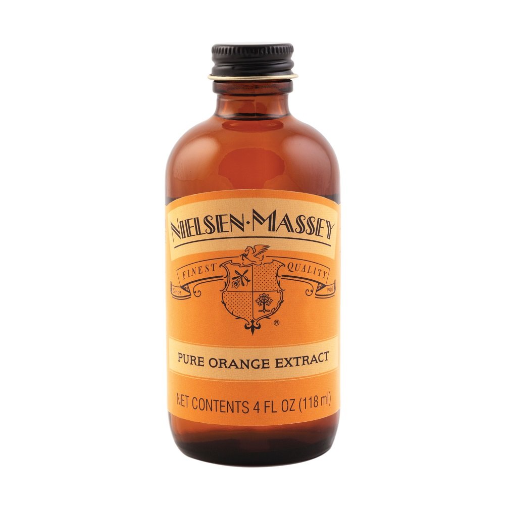 Pouring Nielsen-Massey orange extract to brighten sauces.