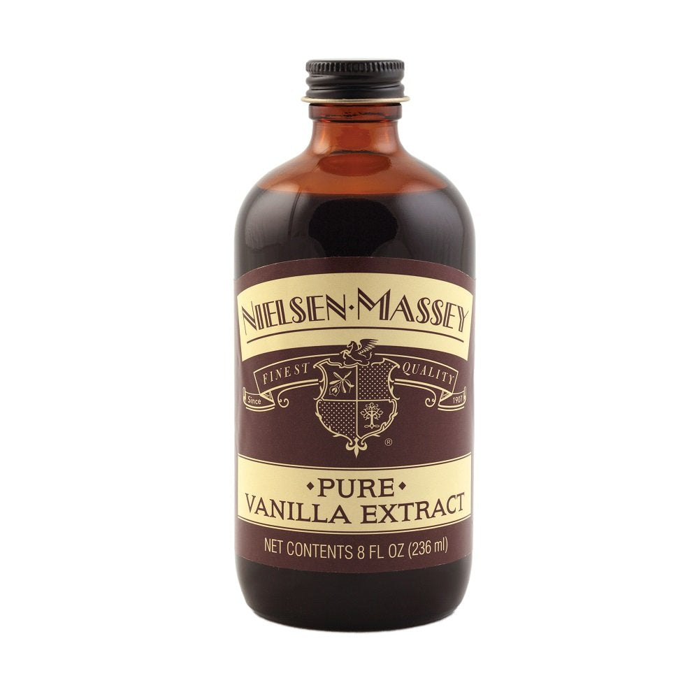 Nielsen-Massey vanilla extract being poured, ideal for desserts and baking.
