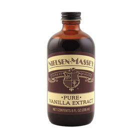 Nielsen-Massey vanilla extract being poured, ideal for desserts and baking.