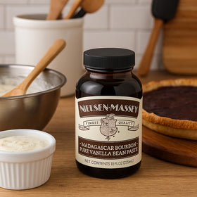Nielsen-Massey Vanilla Bean Paste poured over dessert showcases rich speckled vanilla finish.
