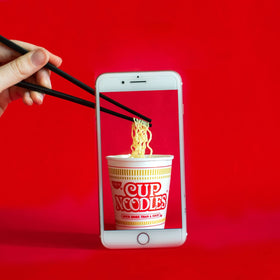 Nissin Cup Noodles Seafood ready-to-eat cup captures convenient lunch on the go.