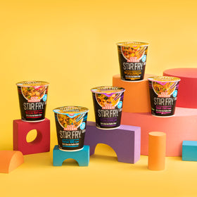 Nissin Cup Noodles Stir Fry Fiery Chicken noodles in a microwave cup for quick prep.