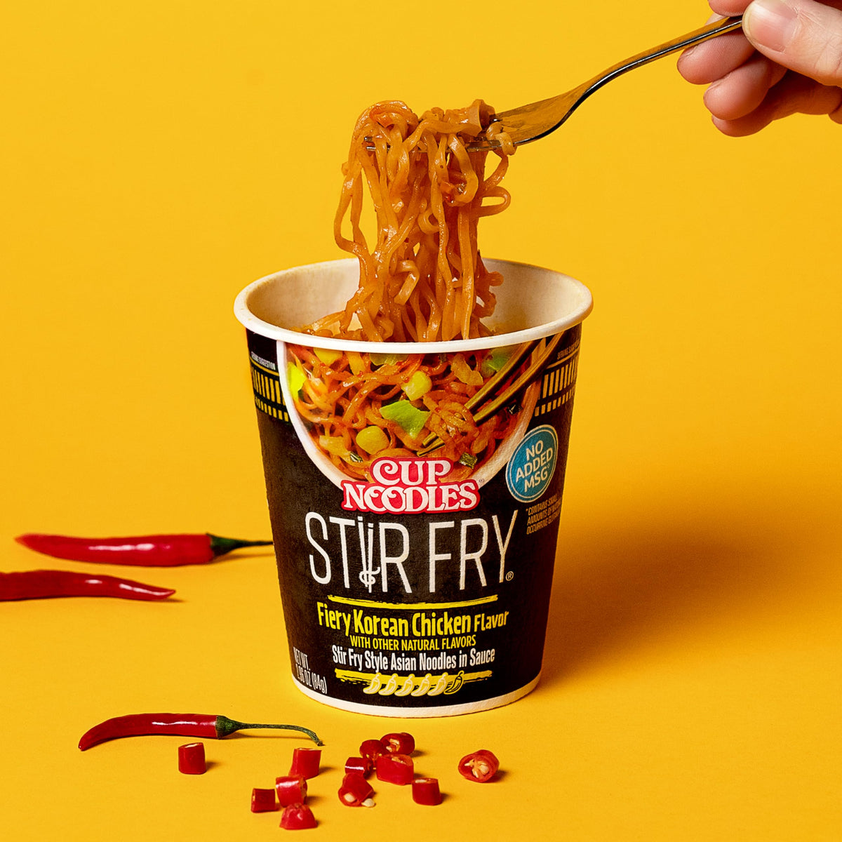 Nissin Cup Noodles Stir Fry Fiery Chicken steaming bowl with vegetables.
