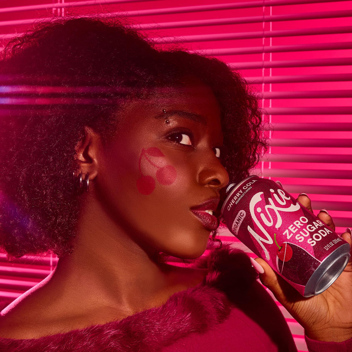 Nixie Cherry Cola pours into a glass, releasing fizz and cherry aroma.