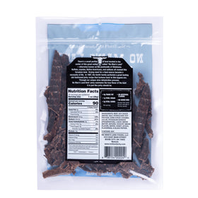 No Man's Land Beef Jerky Black Pepper closeup showing lean beef texture.