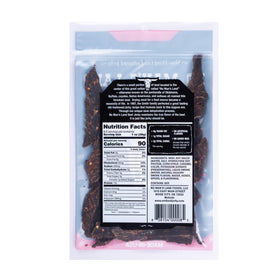 No Mans Land Hot jerky slice close-up, spicy heat and smoky aroma in focus.