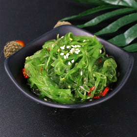 Noble Createaprototype seaweed salad serving bowl showcasing vibrant green strands for sushi night.