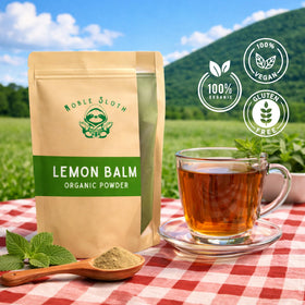 Noble Sloth lemon balm powder with scoop ready for smoothies.