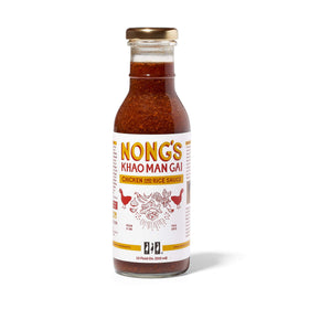 Nong's Khao Man Gai sauce bottle pour highlights bold ginger garlic chili flavor for chicken.