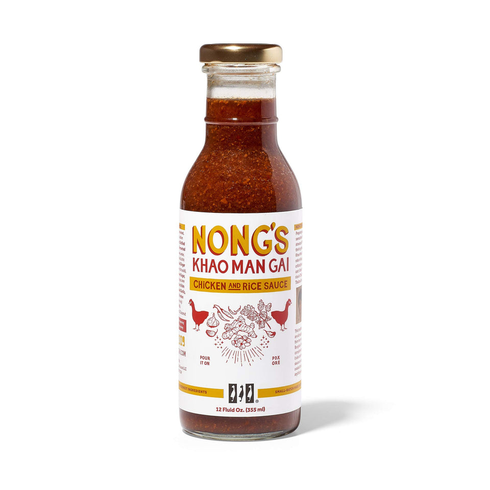 Nong's Khao Man Gai sauce bottle pour highlights bold ginger garlic chili flavor for chicken.