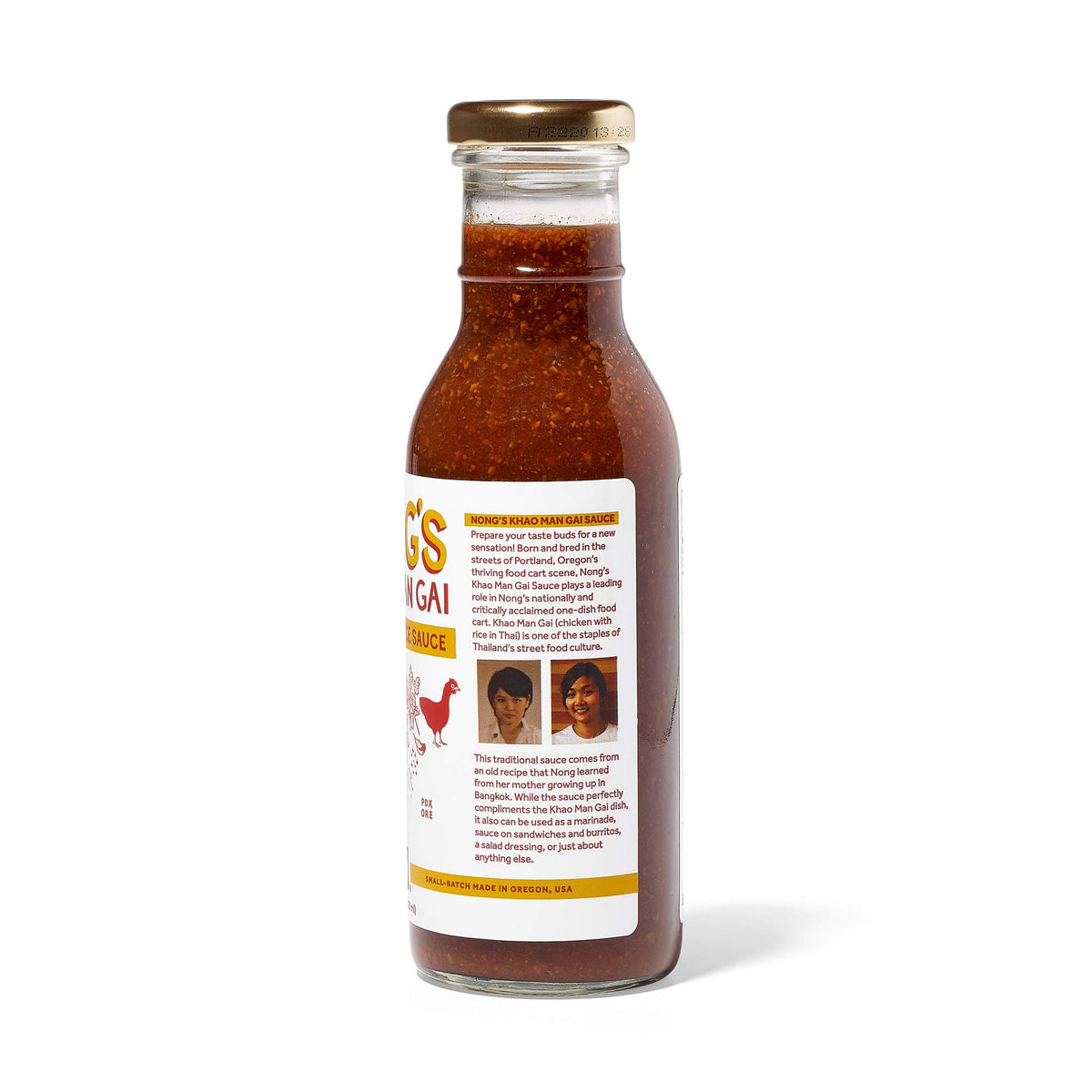 Nong's Khao Man Gai sauce bottle beside vegetables for quick stir-fry flavor boost.