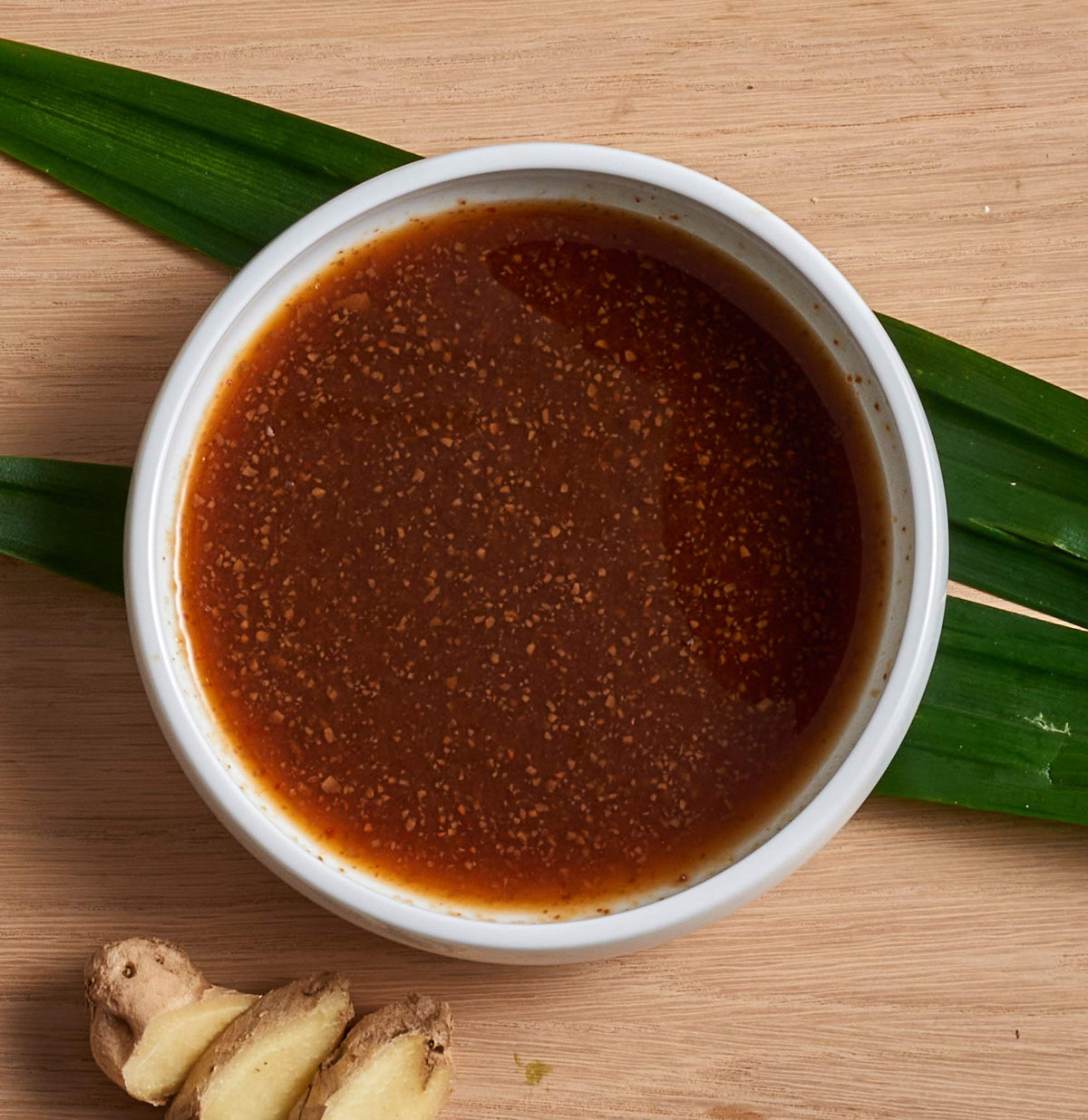 Nong's Khao Man Gai sauce bottle with woman-owned branding.