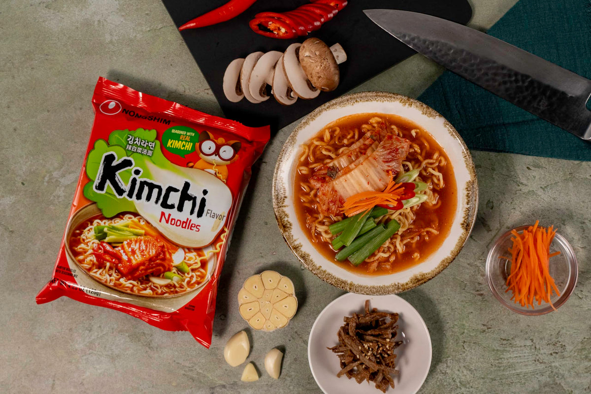 Nongshim chewy noodles soaking up broth for satisfying bites.