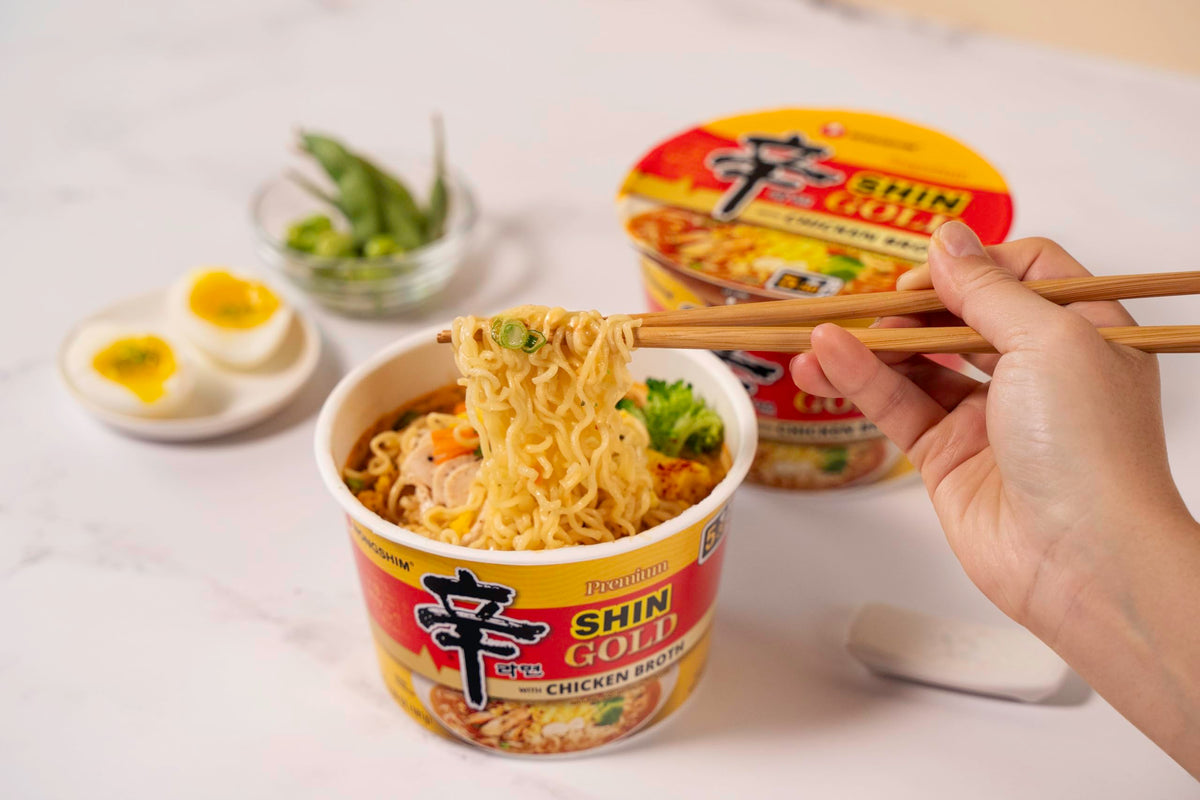 Nongshim Shin Gold noodles steaming in a bowl highlighting aroma and texture
