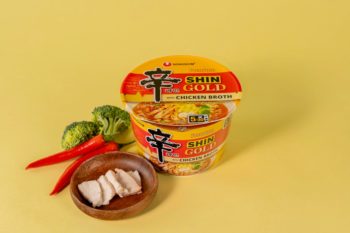 Nongshim Shin Gold broth with visible vegetables for added texture