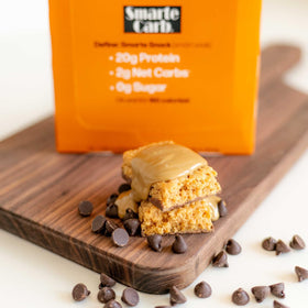 Close-up of NuGo Smarte Carb bar with chocolate coating and peanut butter center